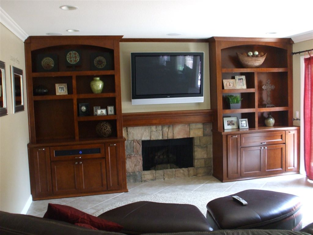 Different&#32;built&#32;in&#32;shelves&#32;have&#32;different&#32;features.&#32;These&#32;show&#32;off&#32;fixed&#32;shelves&#32;and&#32;shaker&#32;style&#32;doors.&#32;The&#32;tv&#32;is&#32;mounted&#32;on&#32;the&#32;wall&#32;above&#32;the&#32;fireplace.
