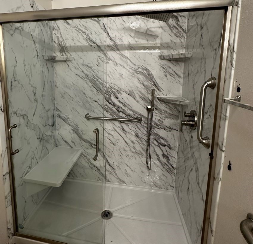 Shower with grab bars and seat for added safety and accessability