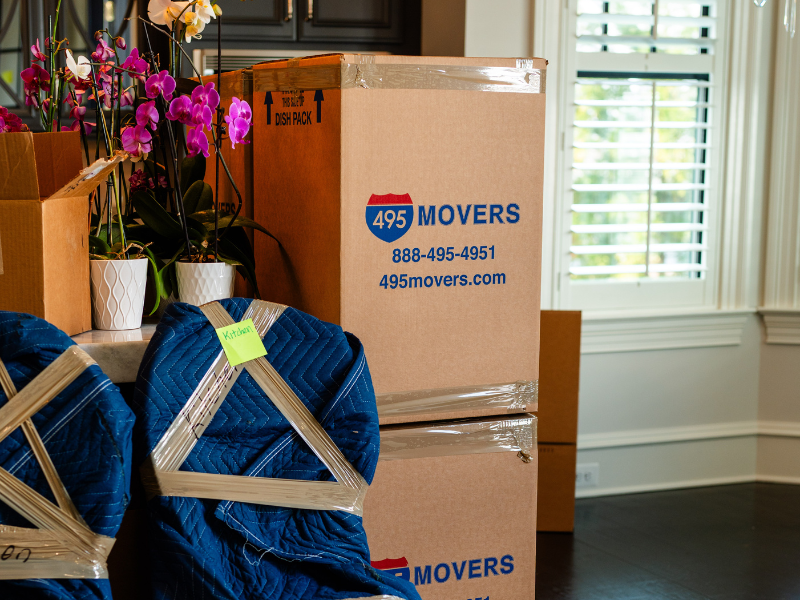 495 Movers moving boxes packed with wrapped chairs