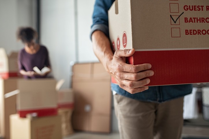 People carrying and unpacking moving boxes