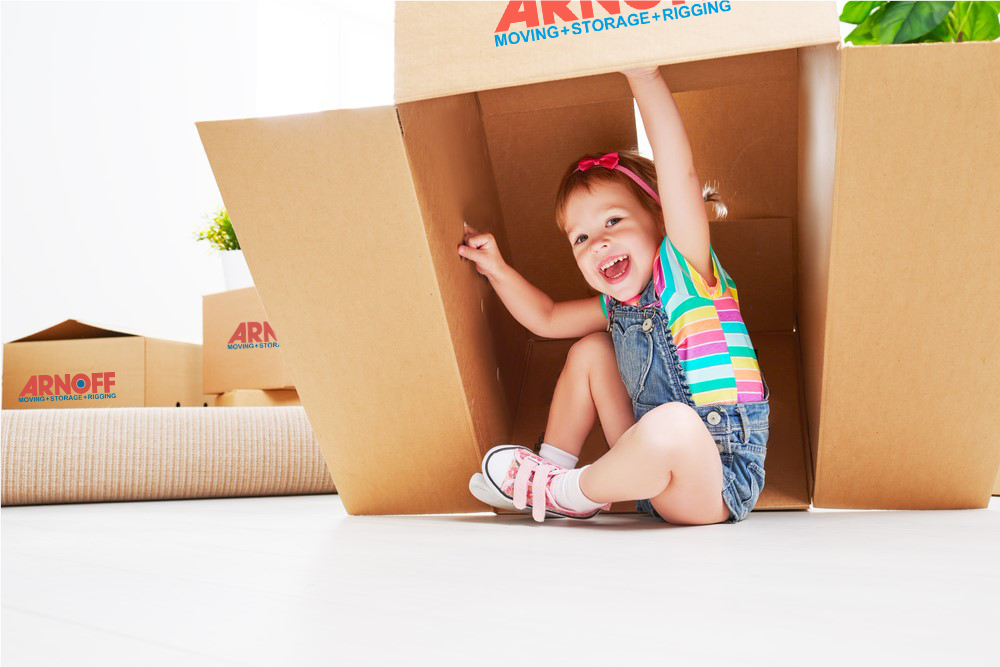 Child playing with moving boxes