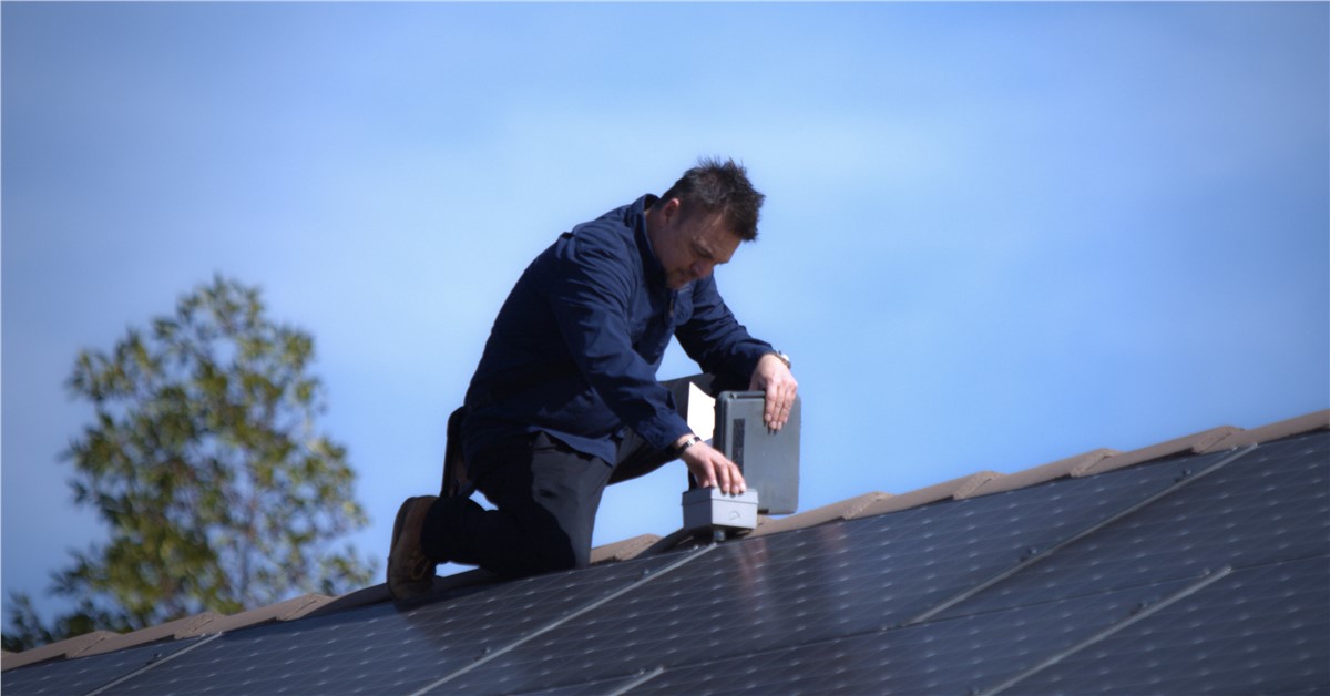August-Roofing-And-Solar-Representative-Doing-A-Solar-Inspection-For-2026-Solar-Tax-Credit