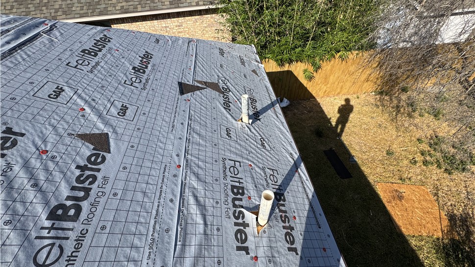 Roofing underlayment installation during Austin TX roof replacement