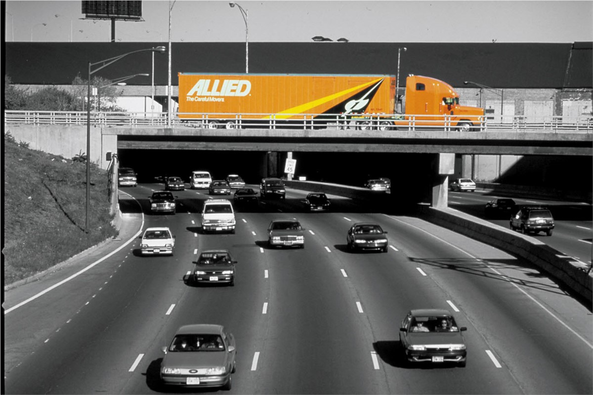 A Moving truck going over an interstate overpass