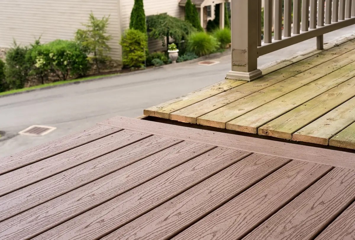 A newly built backyard deck with gray composite decking and white railings