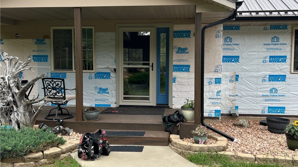 Black Hawk SD home with new James Hardie Night Gray siding and wood-tone garage doors installed by Built Right Roofing & Construction