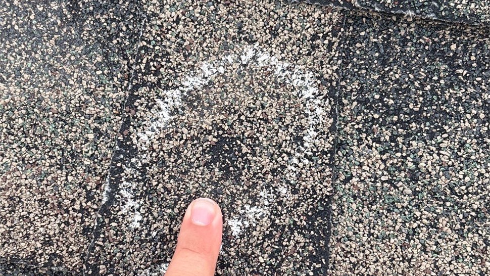 Completed roof replacement in Rapid City, SD with GAF Armor Shield II Shakewood shingles and Almond-colored shingle edge.