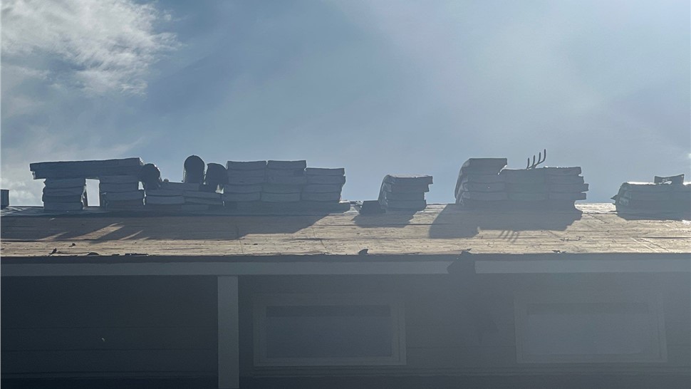 Completed roof replacement in Rapid City, SD with GAF Armor Shield II Shakewood shingles and Almond-colored shingle edge.