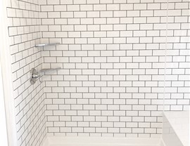 White acrylic shower surround in a subway tile pattern