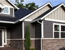 house exterior with stone, horizontal siding, and vertical siding