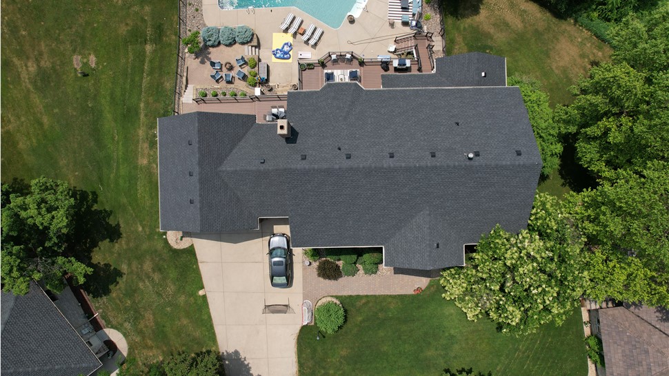 drone image of dark asphalt shingles directly over roof