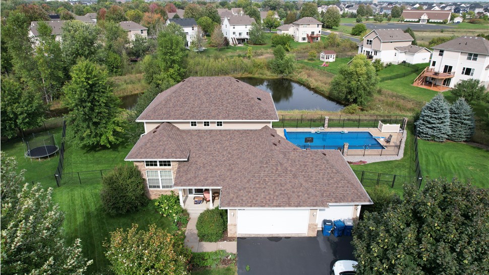 drone image of farmingon mn home with pool