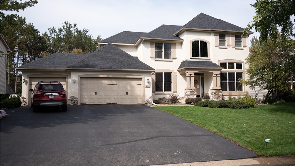 Stucco home with black roof in minnesota