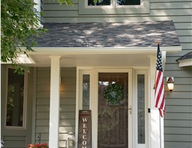 close up of front door with welcome sign and american flag