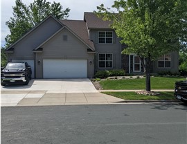 image of two story home with black truck parked in driveway