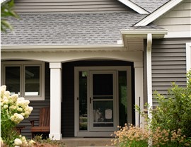 close up of front door of dark gray home
