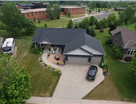 drone image of blue one story home,