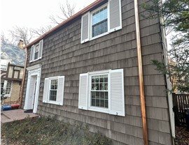 home with wood shake siding and copper gutters