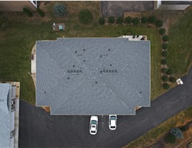 town home, picture taken directly above, the roof forming a perfect rectangle, the roof is a dark gray color