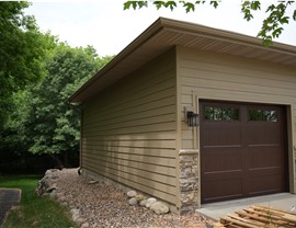 brown siding installed on side of garage