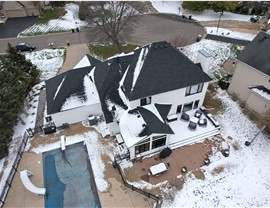 drone image of white home with black roof from GAF