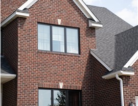 close up of modern black trim windows on brick home