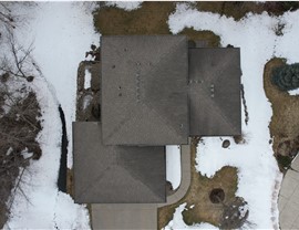 drone image directly over old stained roof