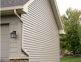 tan gray side of home with vinyl siding
