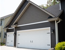 close up of garage with different kinds of vinyl siding to create dimension