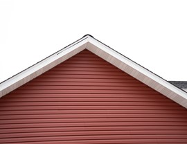 Close up on red home elevation, gray sky in the background