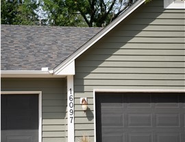 light green siding and gray roof close up of garage