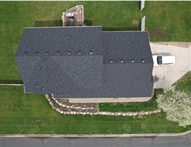 drone image of a home, directly above, the roof forms a rectangle filled with black shingles
