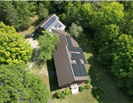 drone image of mid-century modern home in the forrest