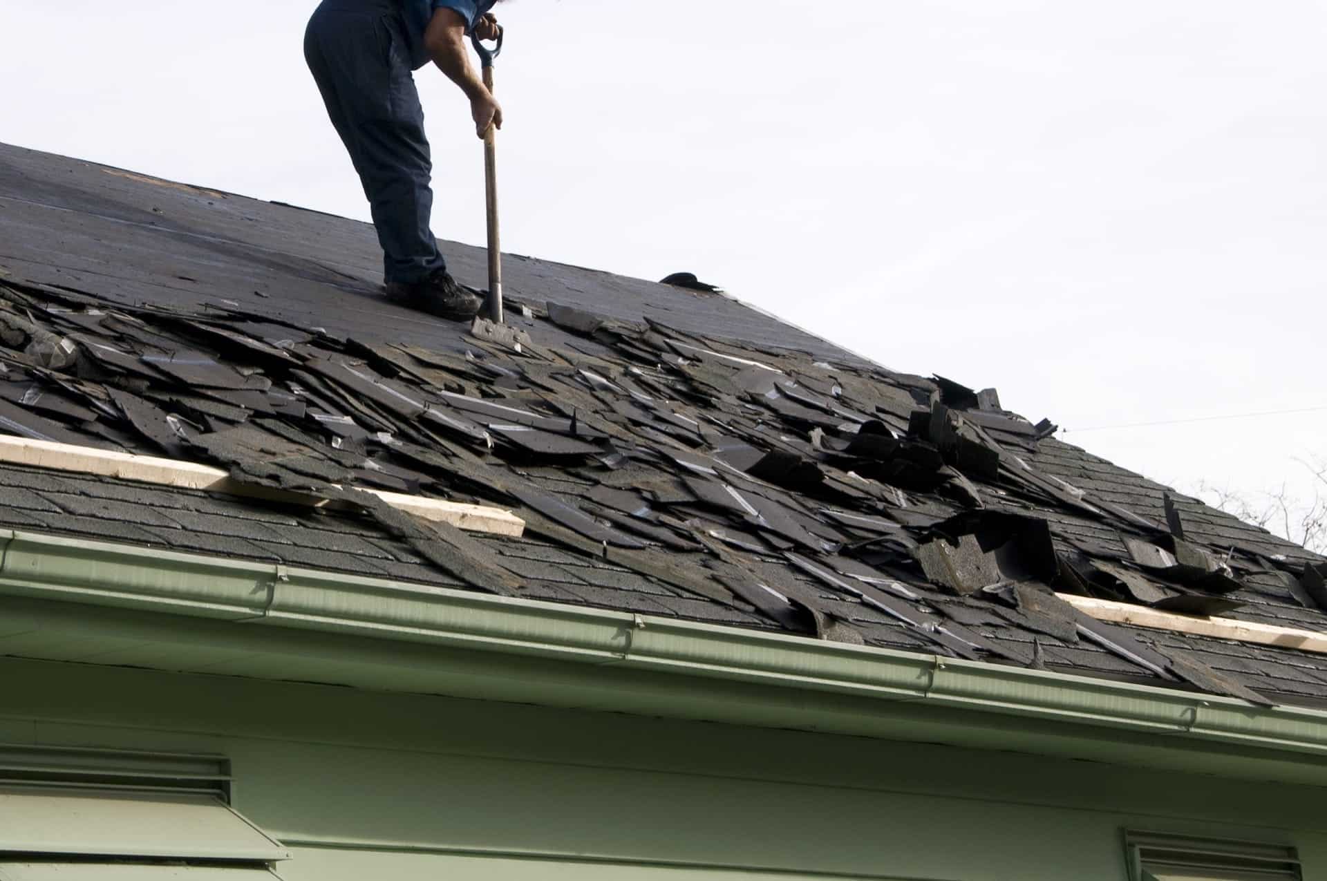 Photo of a Roofer Removes Old Shingles