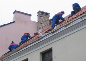 Roofers Work on a Tile Roof.