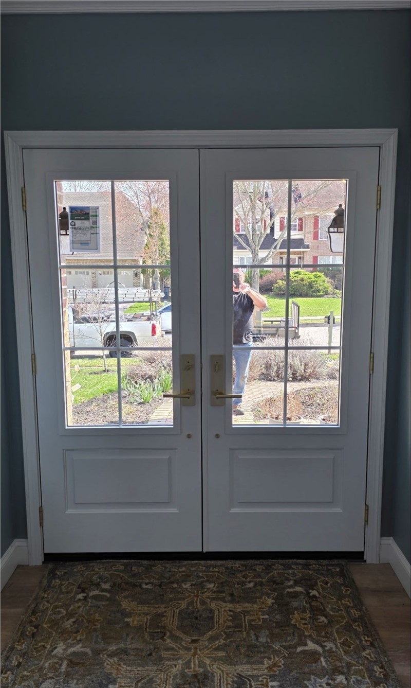 Interior view of fiberglass French door replacement in Collegeville PA featuring glass panels and upgraded entry system installed by Earth Smart Remodeling