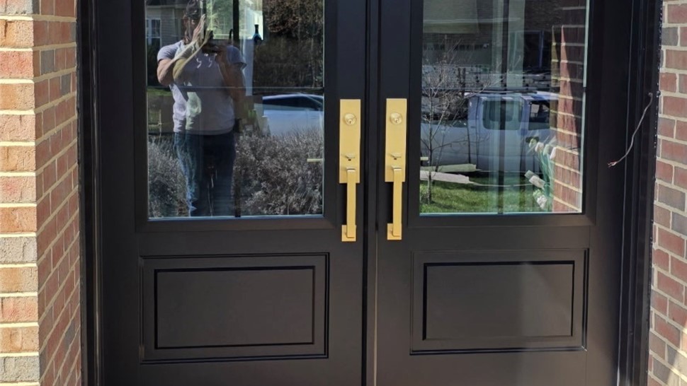 Exterior French door replacement in Collegeville PA with black fiberglass French doors and brass hardware installed by Earth Smart Remodeling