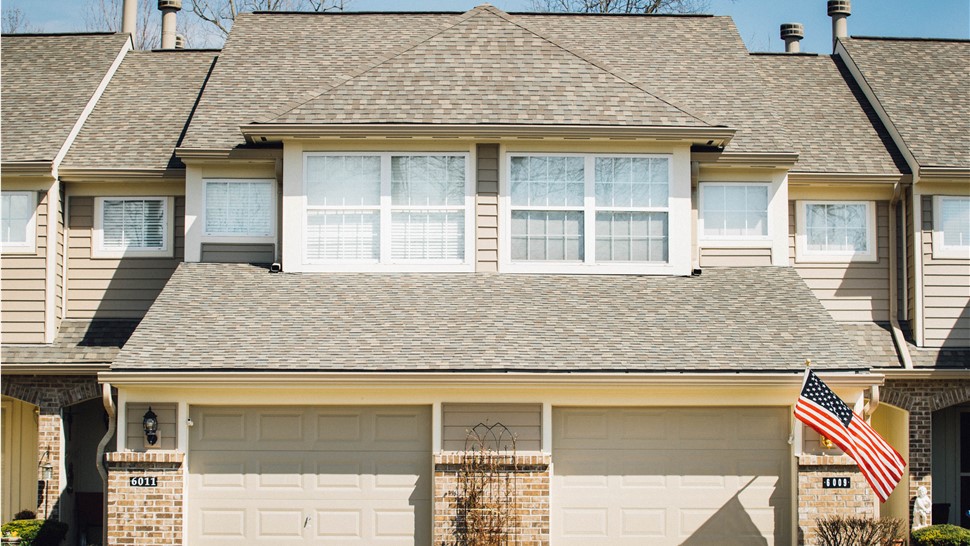 A home with a light brown shingle roof