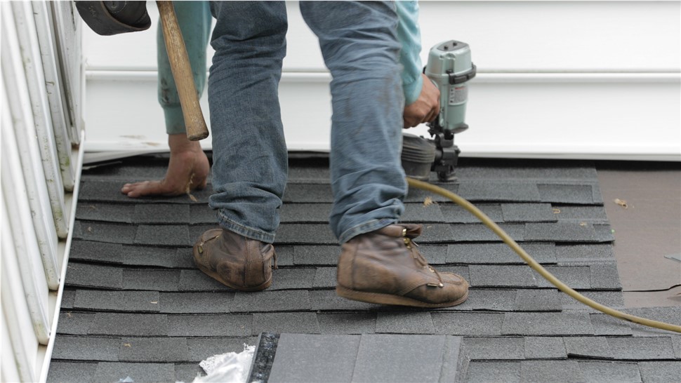A man is laying a new roof