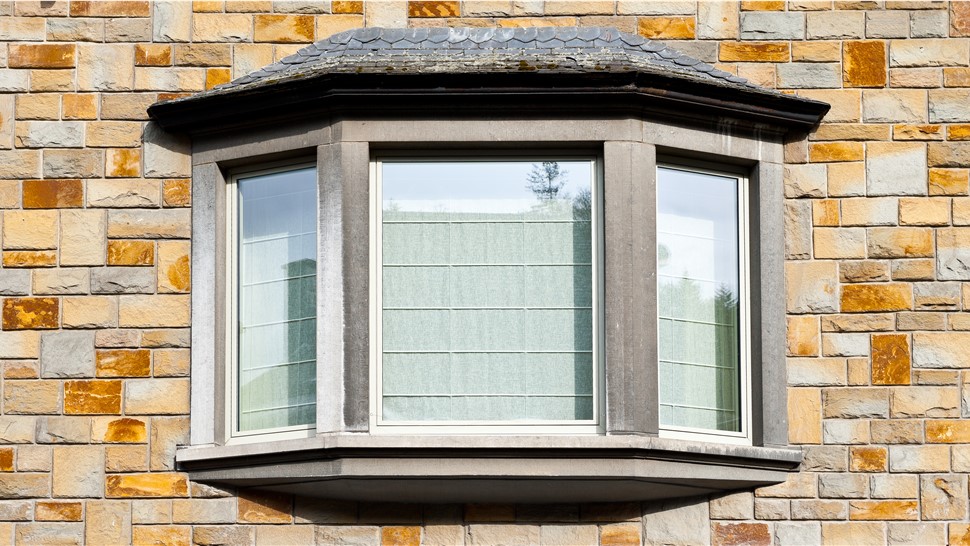 A bay window on a brick exterior wall