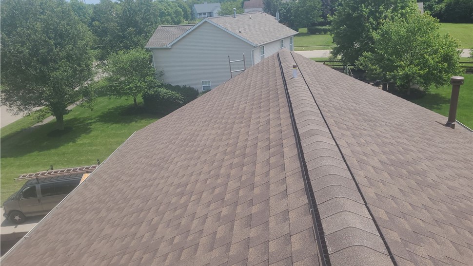 Newly installed Barkwood GAF Timberline HDZ shingles on a roof in Liberty Township, OH, showcasing a ridge vent system for improved ventilation and a natural wood-tone aesthetic.
