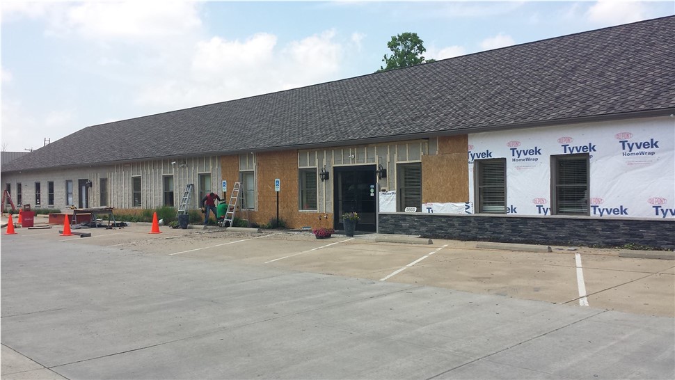 A building with a brown roof still under construction