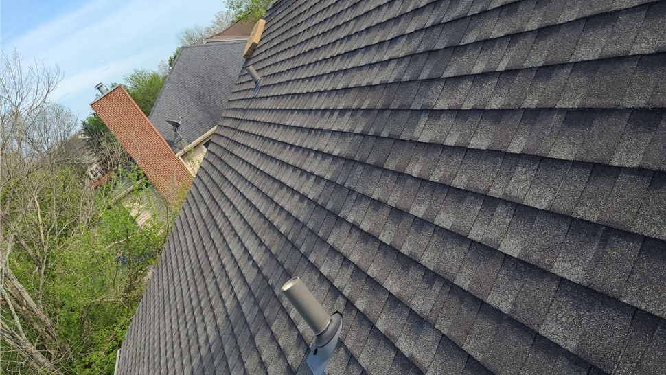 Roof replacement in Milford, Ohio, showcasing Weathered Wood Timberline UHDZ shingles under a clear blue sky, with a smooth and seamless finish.
