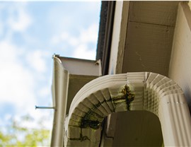 Broken gutters on the side of a home