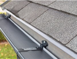 Looking down at gutter guards on the side of a home