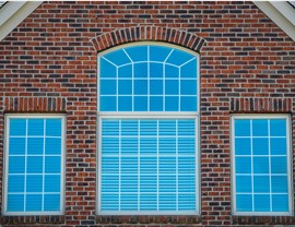 Massive windows on the brick exterior wall of a home