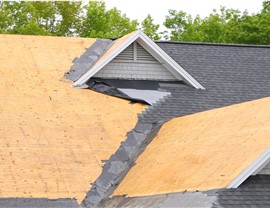 An aerial view of a roof that has had it's damaged shingles removed