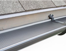 Looking down at gutter guards on the side of a home