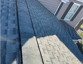 A Slate Timberline HDZ shingle roof in Mount Lookout with gray tones, ridge vents, and a dormer window.