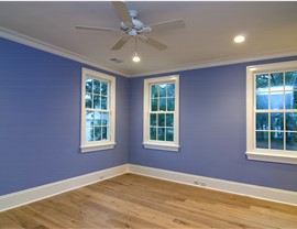 A room with purple walls and new windows